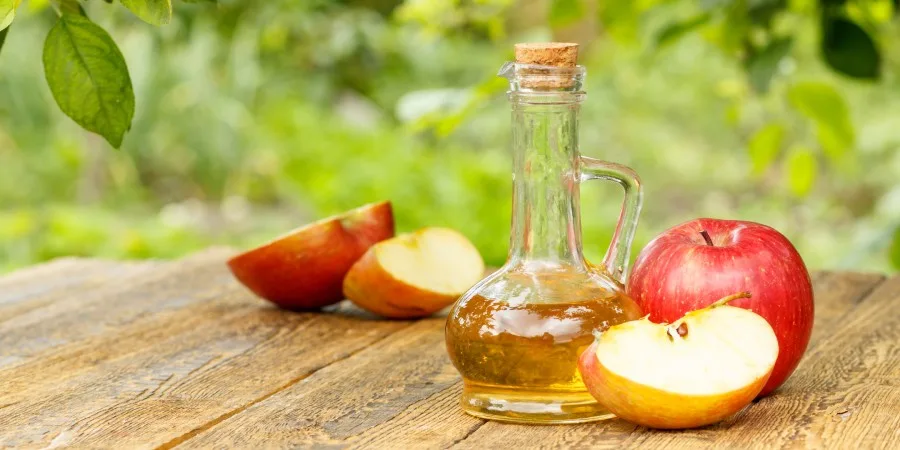 8 Science-Backed Health Benefits of Apple Cider Vinegar - acv table outside